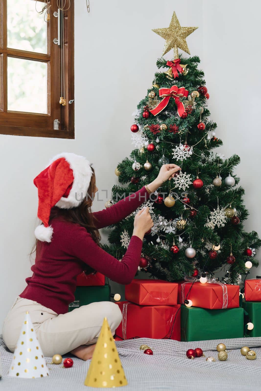 Cheerful lady surprised of the present after the opening in the gift box. Marry Christmas and Happy Holidays and New Year eve celebrating concept.