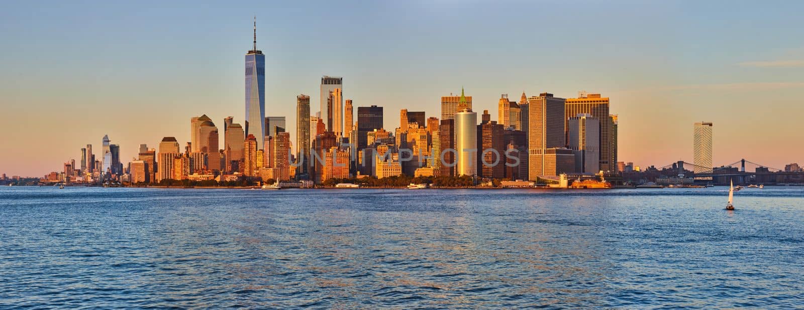 Stunning golden light over southern Manhattan panoramic skyline from waters by njproductions
