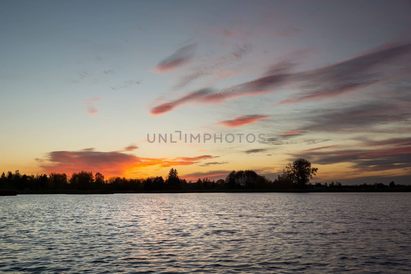 Sunset and colorful clouds over the lake water, Stankow, Poland