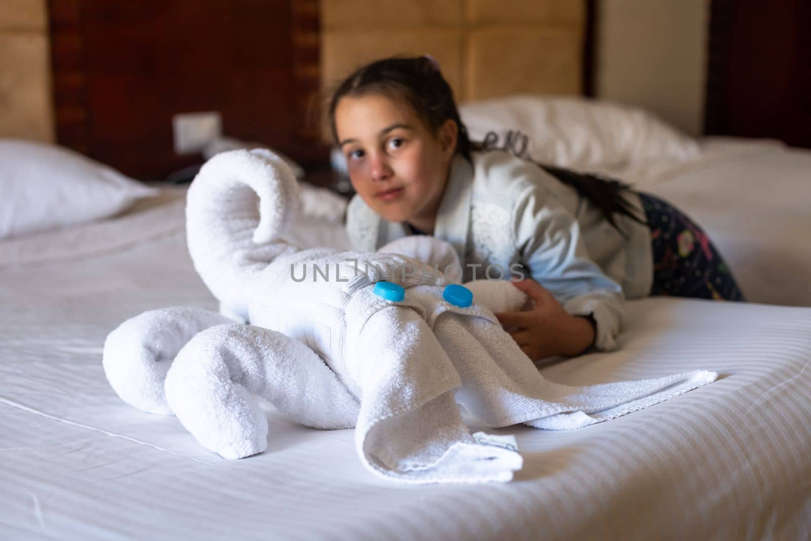 A squid made of towels on a bed in a hotel.