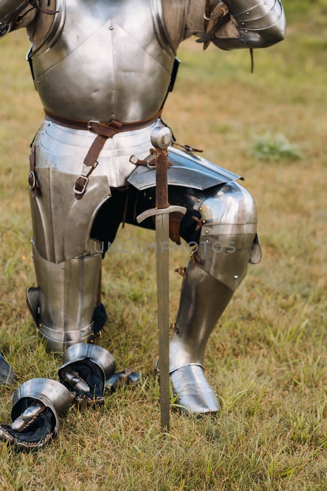 Close-up of a medieval knight in armor preparing for battle.
