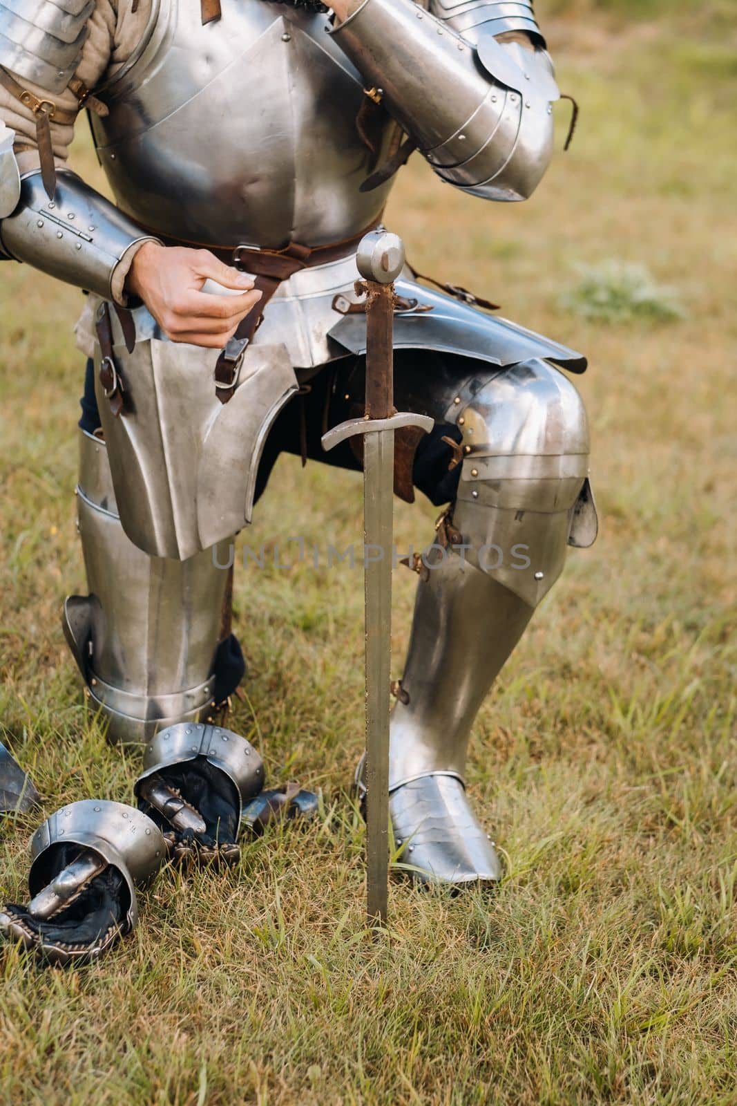 Close-up of a medieval knight in armor preparing for battle.