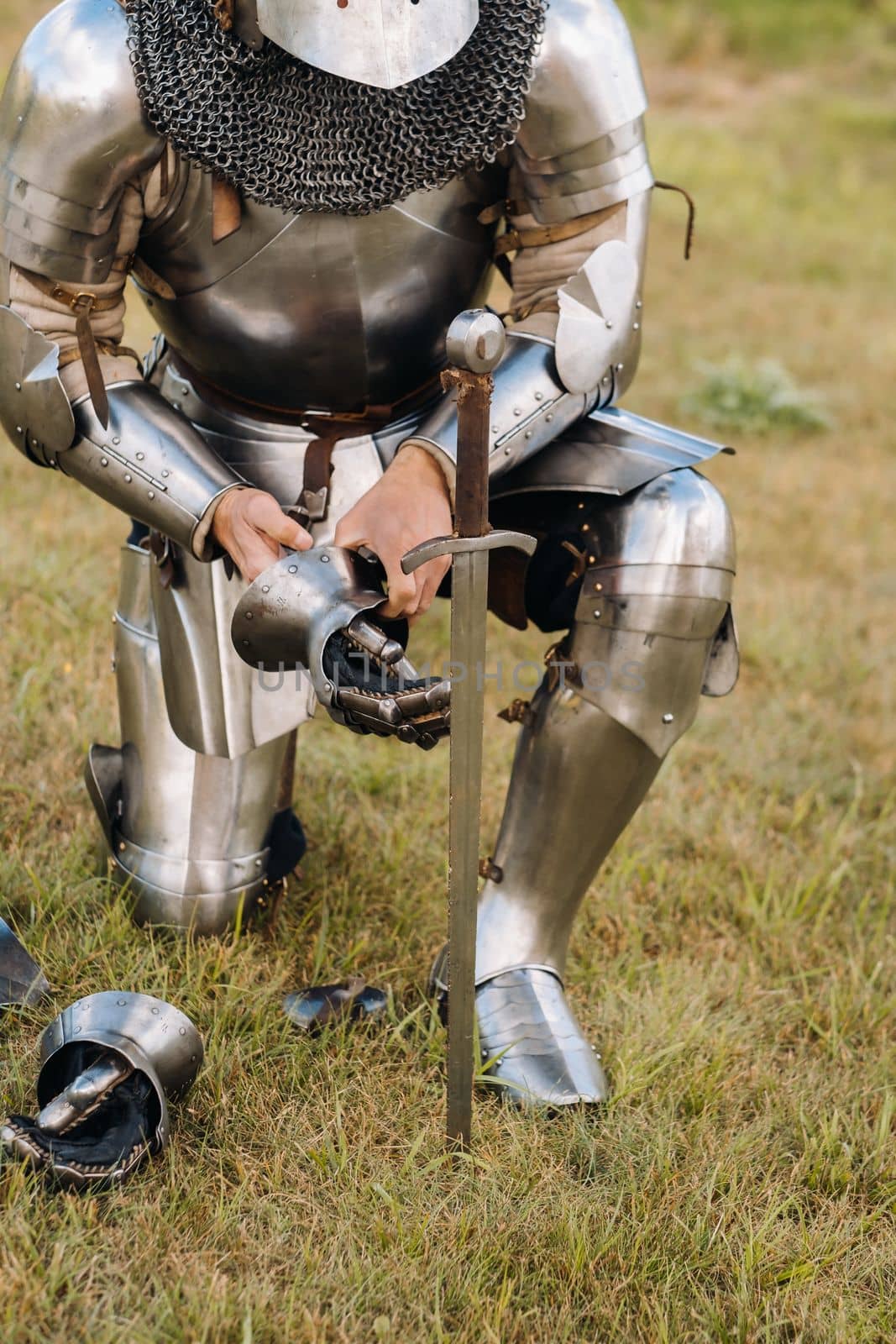 Close-up of a medieval knight in armor preparing for battle.