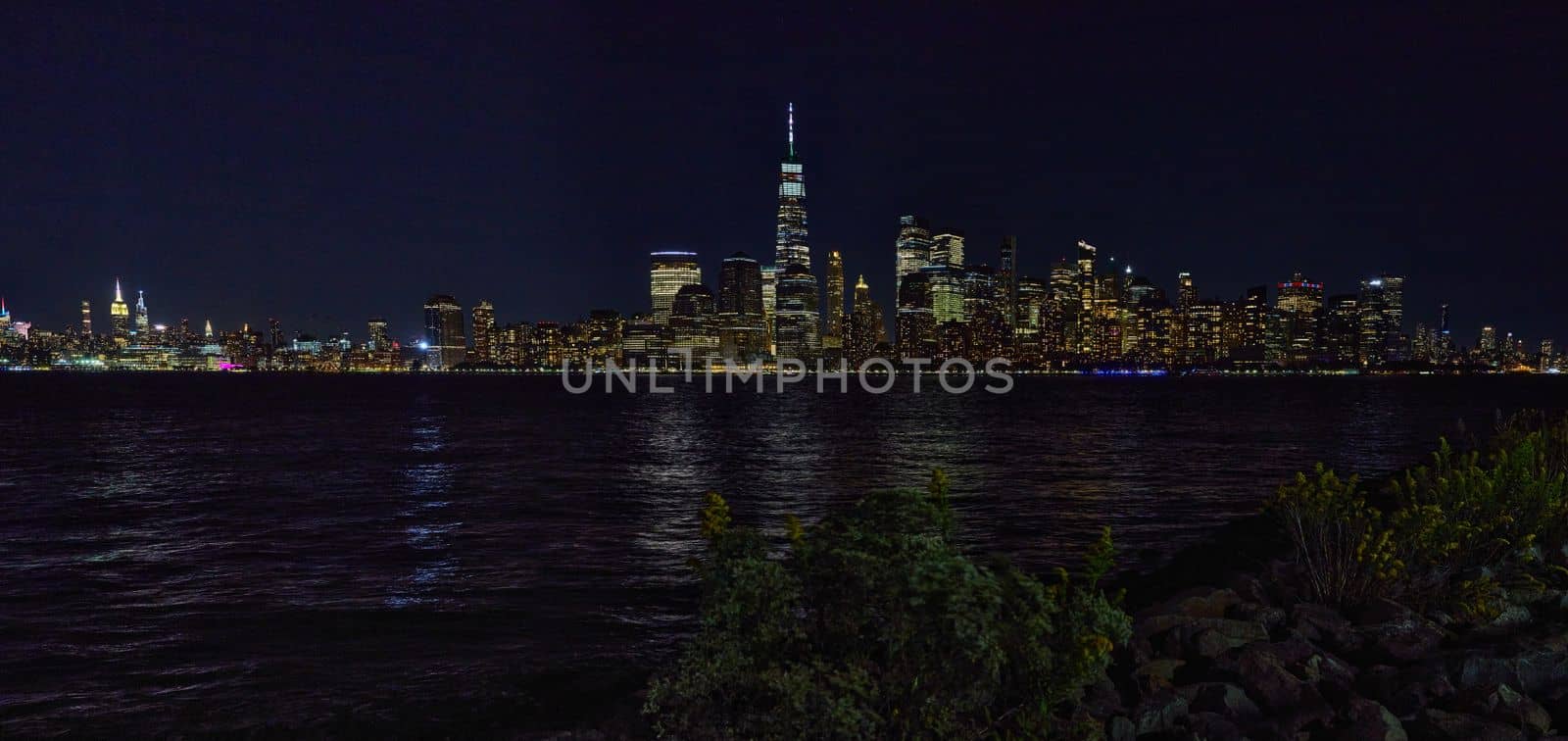 Full wide panoramic New York City skyline at night from New Jersey with city lights by njproductions