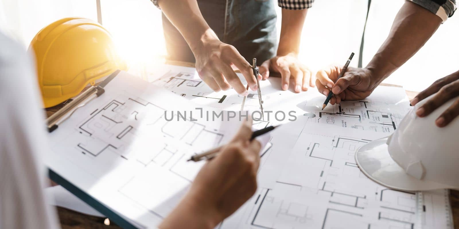 professional architect designer structural engineer team colleagues working office. Architects discussing at the table, team work and work flow construction concept.