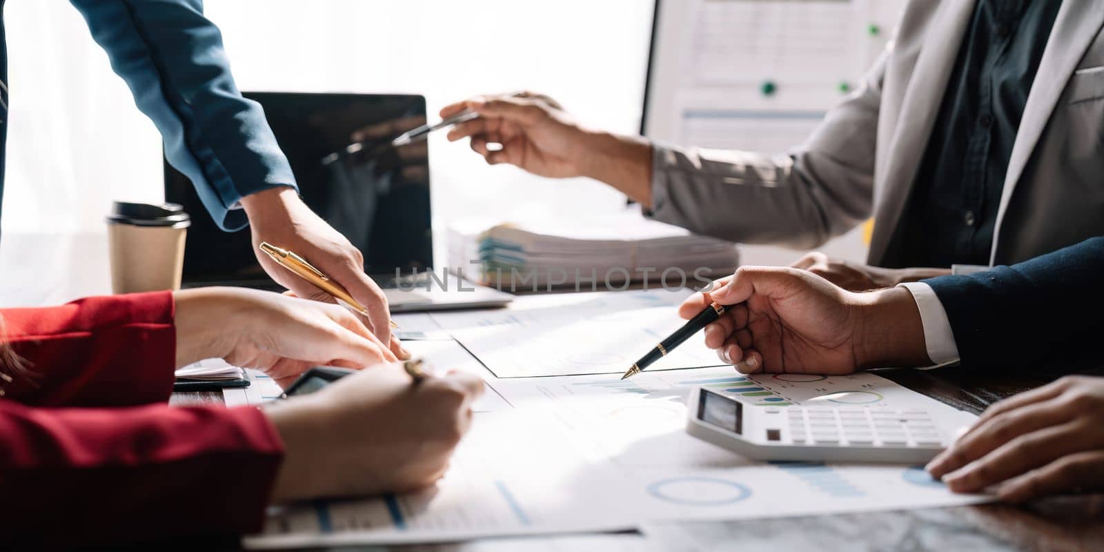 Businesspeople analyzing investment graph meeting brainstorming and discussing plan in meeting room, investment concept.