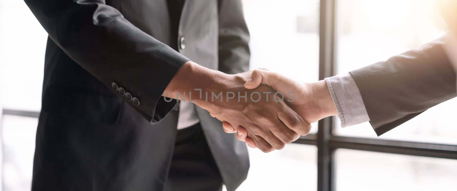 Business people shaking hands, finishing up meeting, business etiquette, congratulation, merger and acquisition concept.