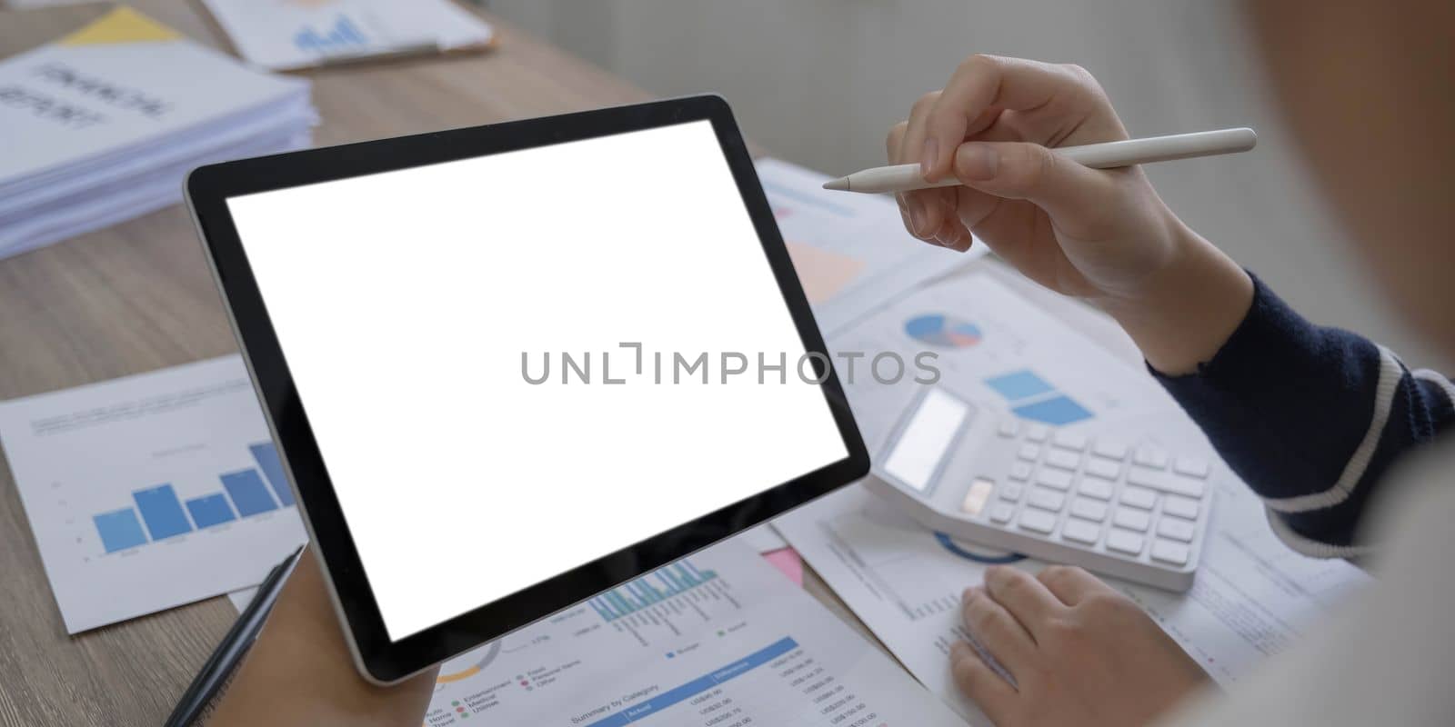 Mockup image of a woman holding digital tablet with blank white desktop screen.