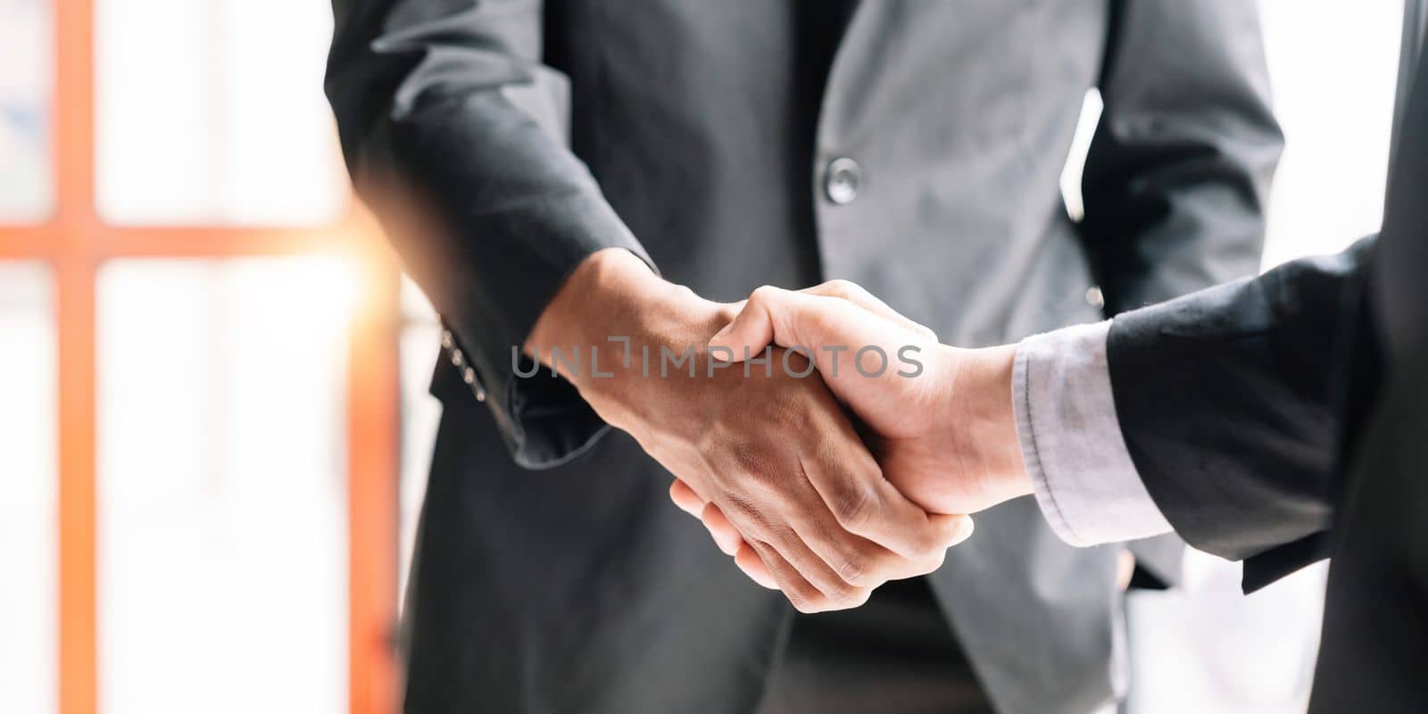 Business people shaking hands, finishing up meeting, business etiquette, congratulation, merger and acquisition concept by nateemee