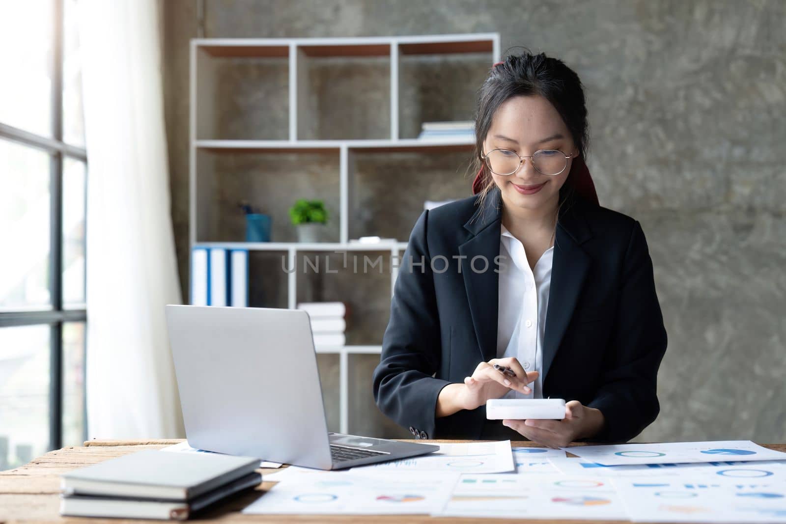 Young professional Accountant Woman In Office Doing Accounting with calculator in office.