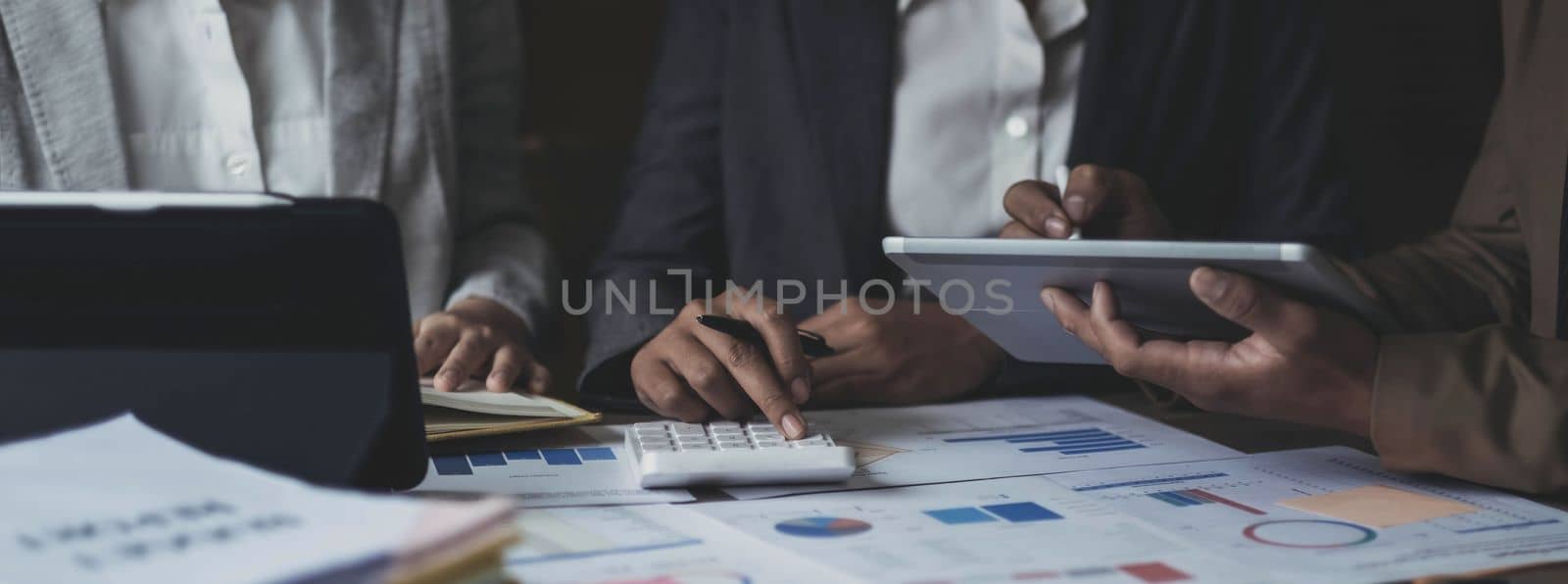 Asian business adviser meeting to analyze and discuss the situation on the financial report in the meeting room.Investment Consultant, Financial advisor and accounting concept.