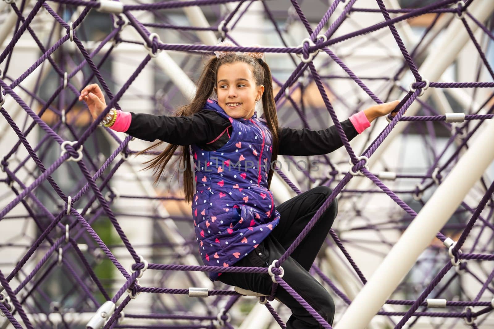 Cute teenage girl in the rope labyrinth kid park attraction by Andelov13