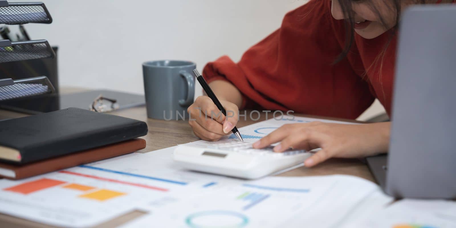 Tax accountant asian woman working with financial and paperwork.