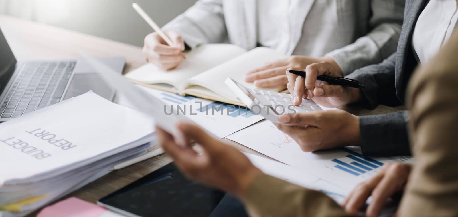 Asian business adviser meeting to analyze and discuss the situation on the financial report in the meeting room.Investment Consultant, Financial advisor and accounting concept.