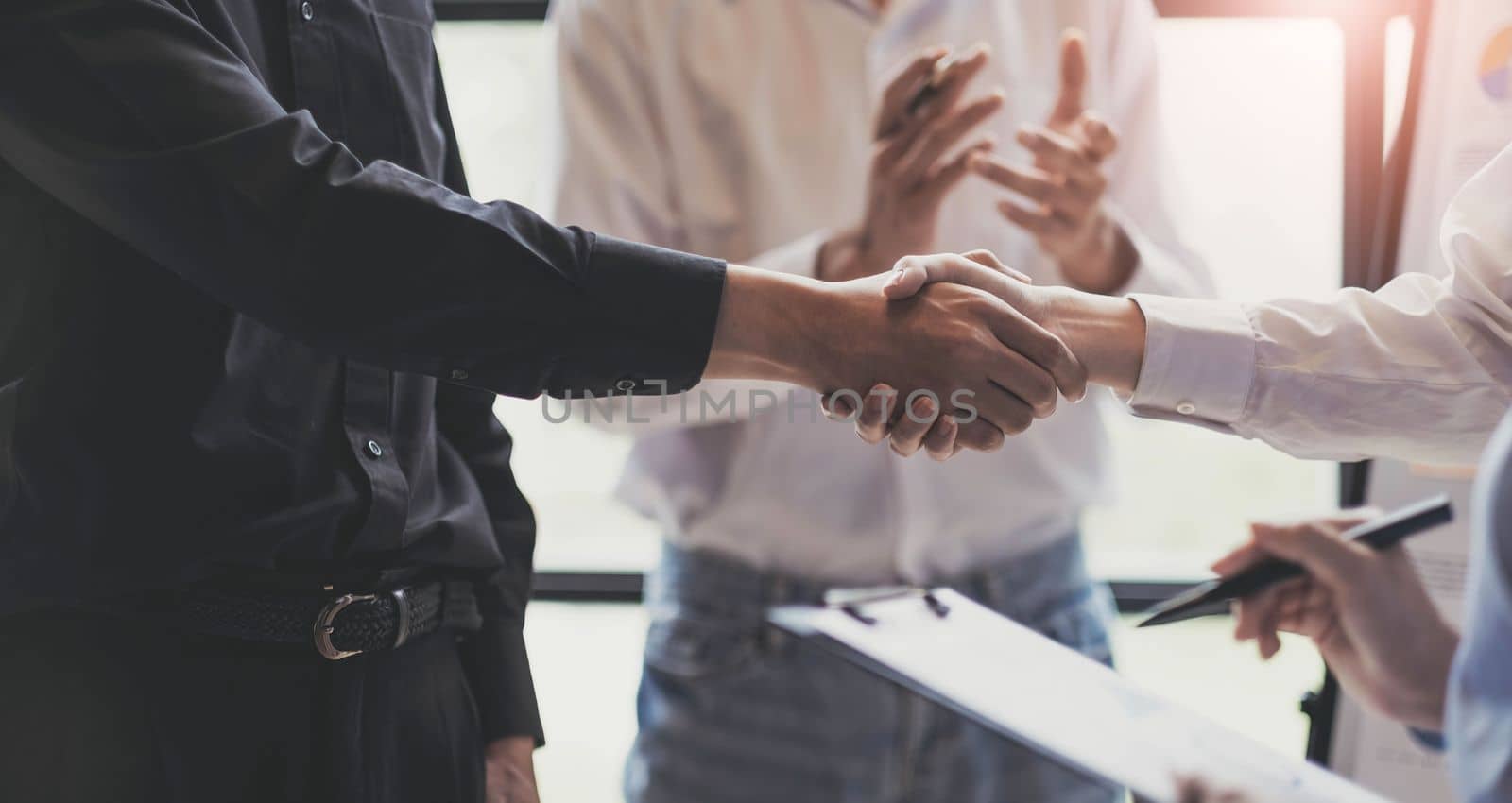 Business handshake for teamwork of business merger and acquisition,successful negotiate,hand shake,two businessman shake hand with partner to celebration partnership and business deal concept.