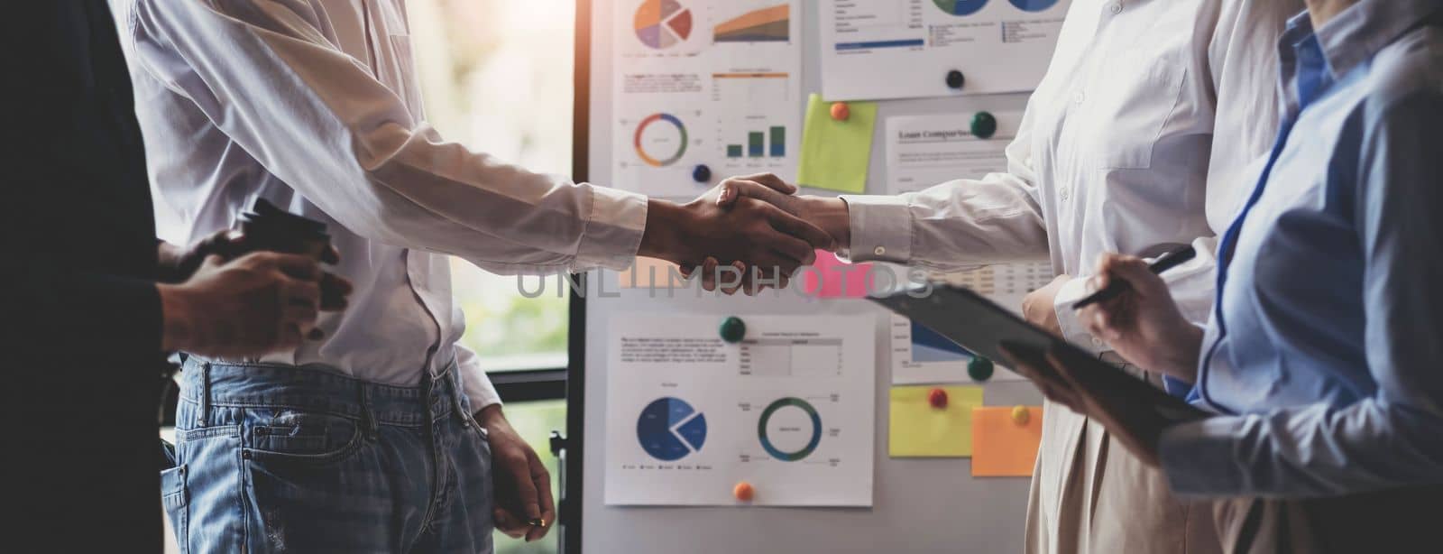 Business handshake for teamwork of business merger and acquisition,successful negotiate,hand shake,two businessman shake hand with partner to celebration partnership and business deal concept.