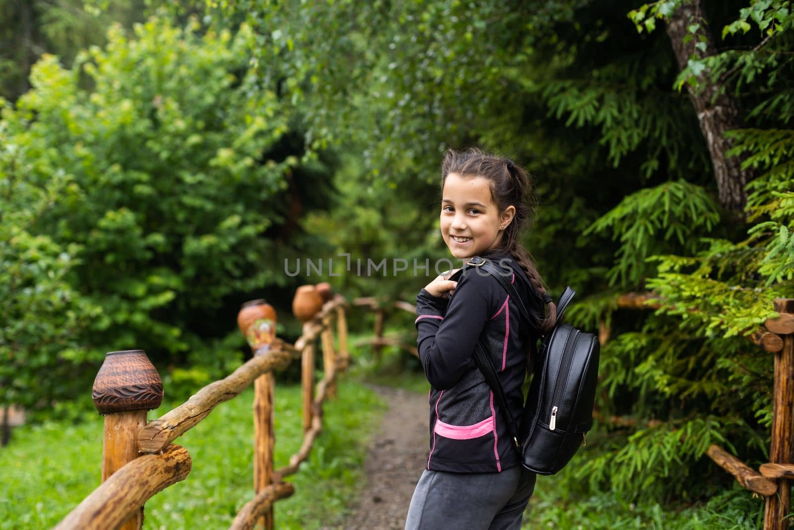 Back to school. Cute child girl with backpack going to school with fun.