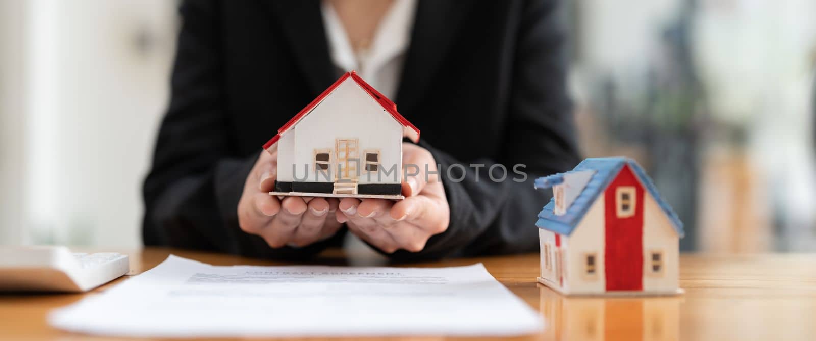 House model with real estate agent and customer discussing for contract to buy house, insurance or loan real estate background.