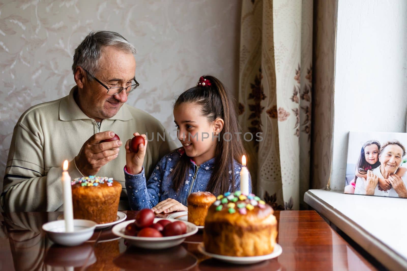Grandfather and granddaughter with Easter cake eggs by Andelov13