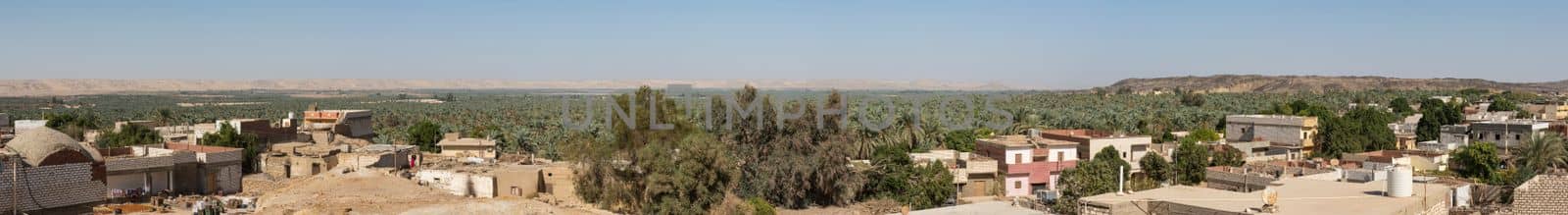 Panoramic view over remote african town with oasis by paulvinten