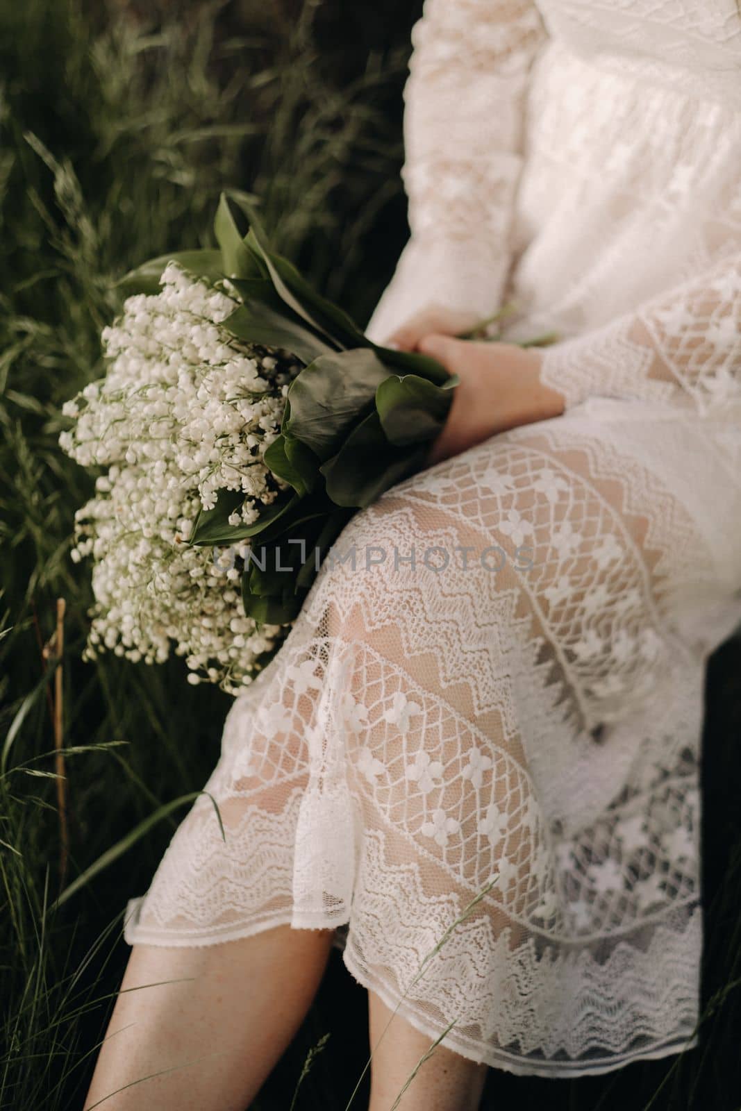 Close-up of lilies of the valley holding in the hands of a girl. Spring flowers
