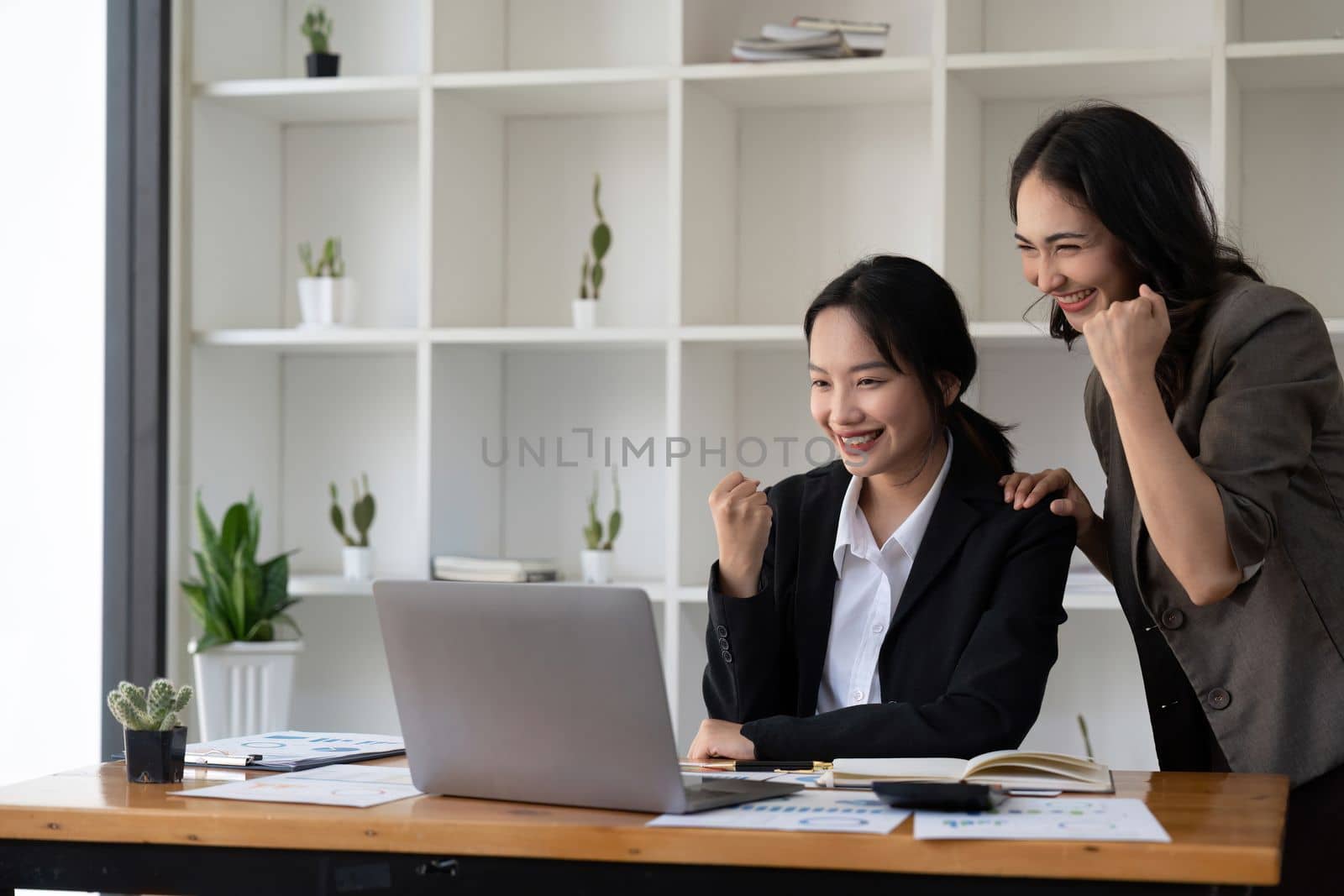 Group of Young Asian business team creative businesspeople coworker in office Happy to be successful partnership teamwork celebrating achievement and success concept.