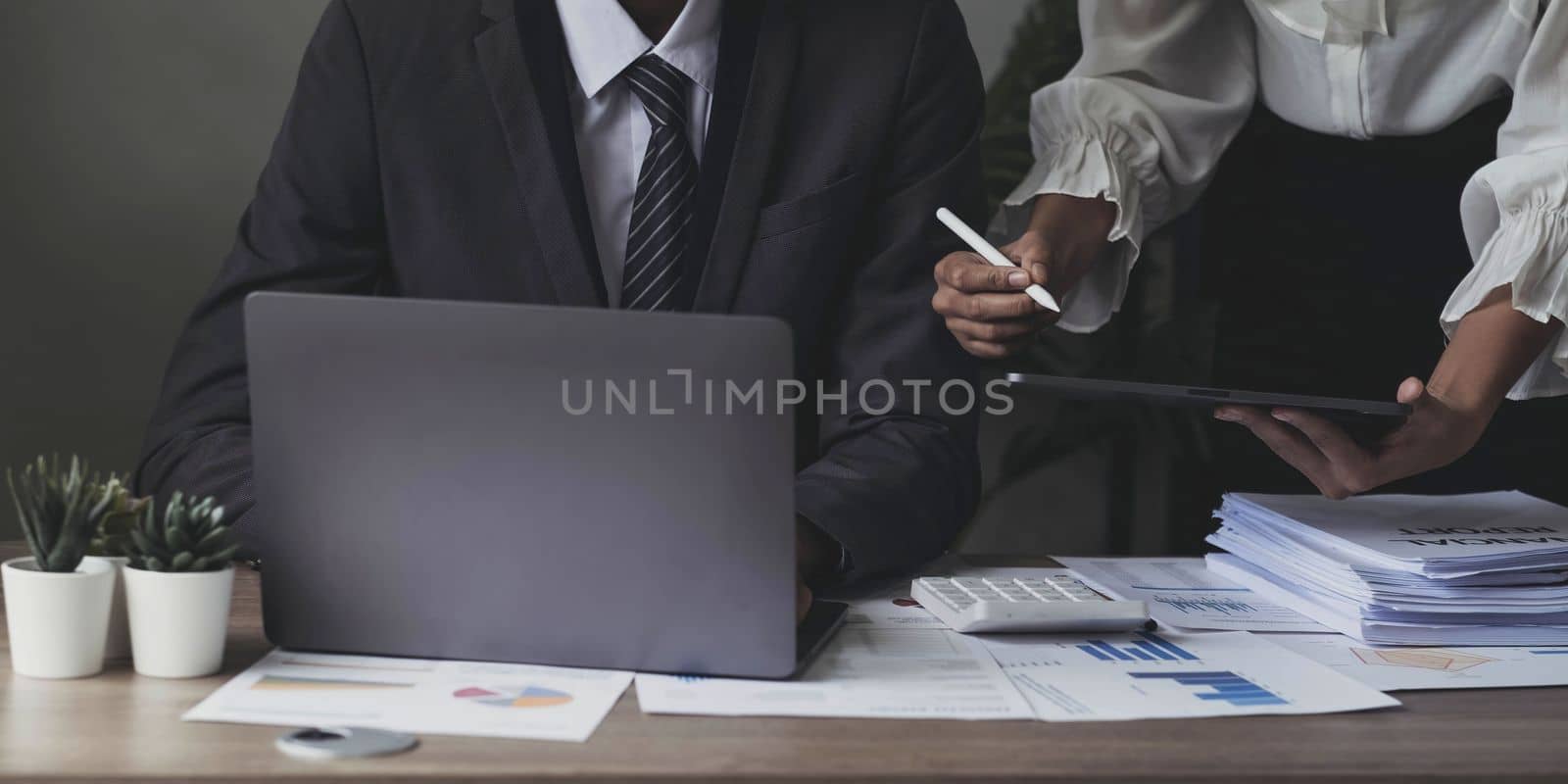 Asian business adviser meeting to analyze and discuss the situation on the financial report in the meeting room.Investment Consultant, Financial advisor and accounting concept.