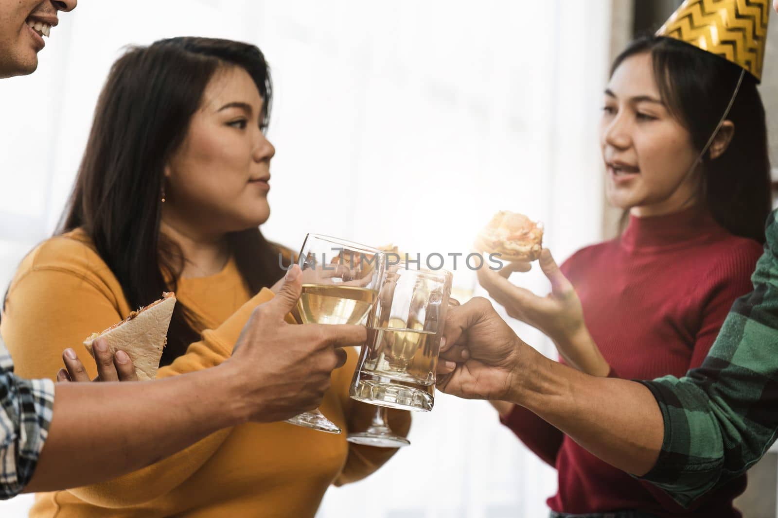 Group of happy colleagues having fun at a new year celebration or business success. Coworkers with diverse people at the office party.