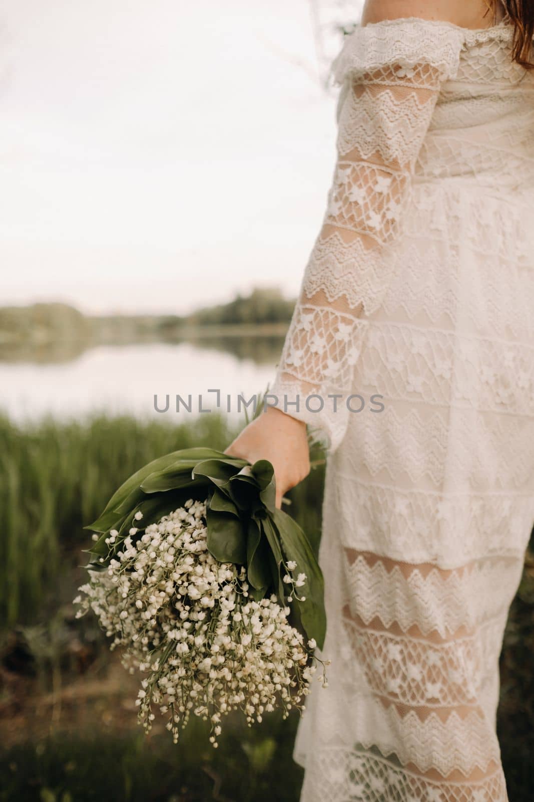 Close-up of lilies of the valley holding in the hands of a girl. Spring flowers