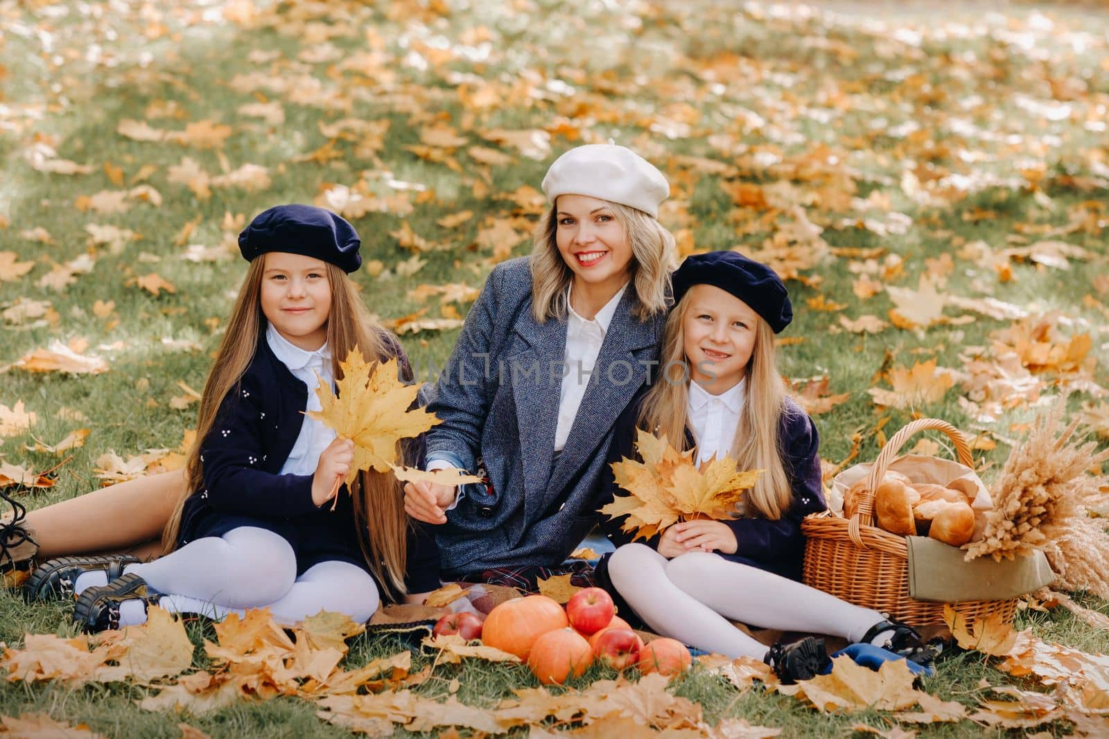 A big family on a picnic in the fall in a nature park. Happy people in the autumn park.