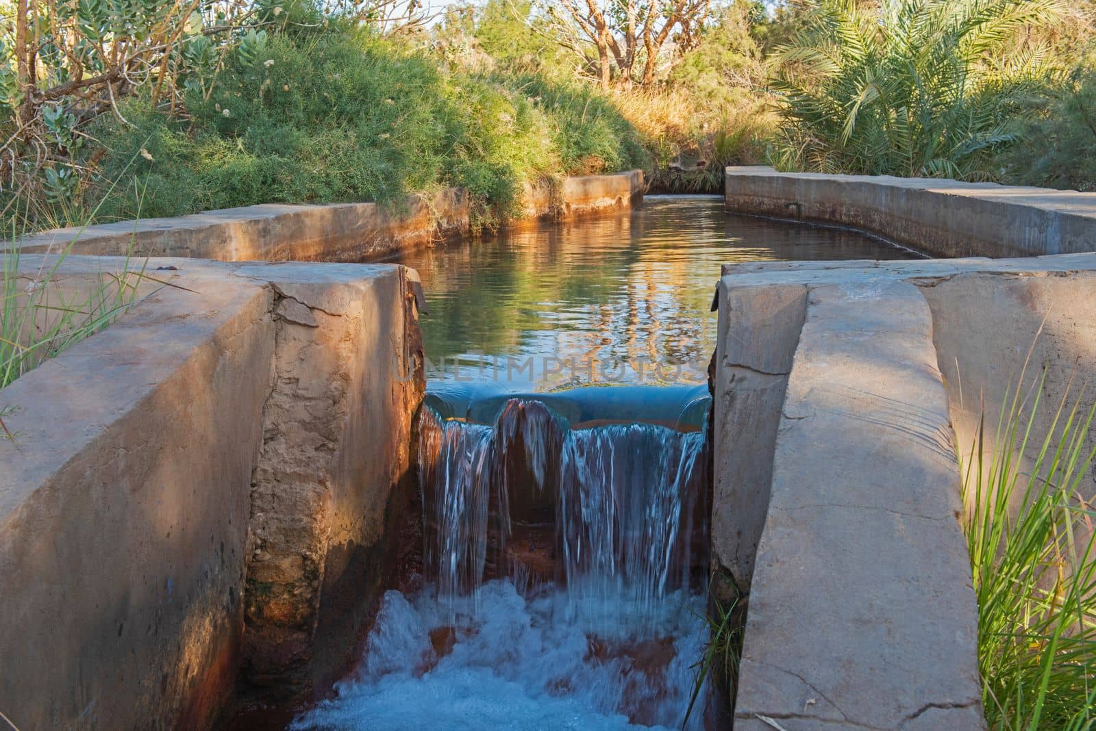 Closeup detail of water in hot spring pool trough at african egyptian oasis spring well