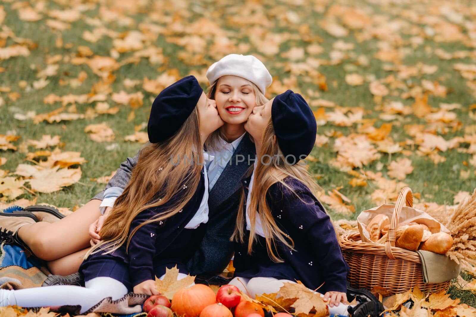 A big family on a picnic in the fall in a nature park. Happy people in the autumn park.