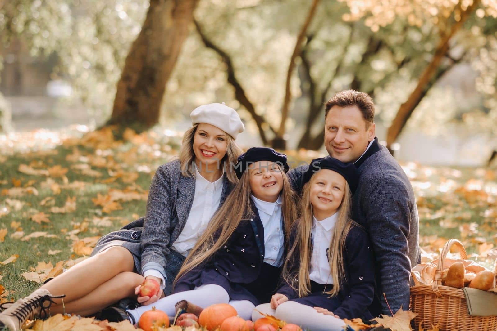 A big family on a picnic in the fall in a nature park. Happy people in the autumn park.