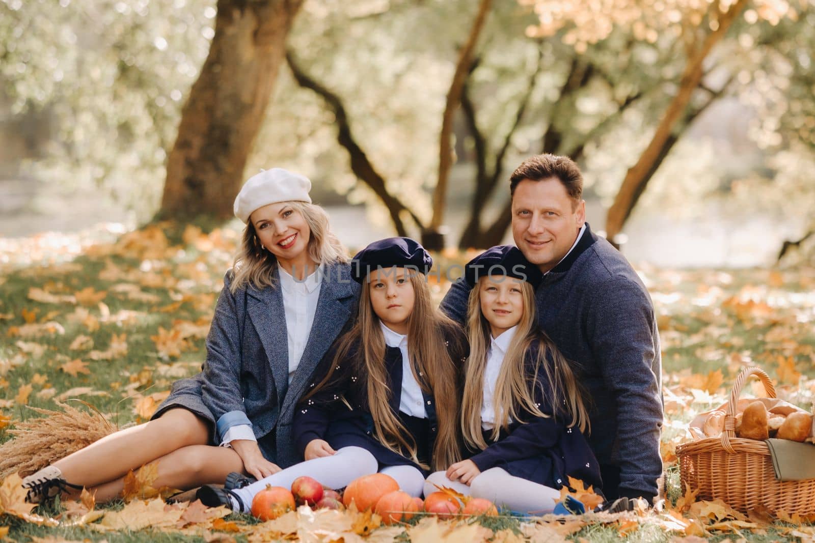 A big family on a picnic in the fall in a nature park. Happy people in the autumn park.