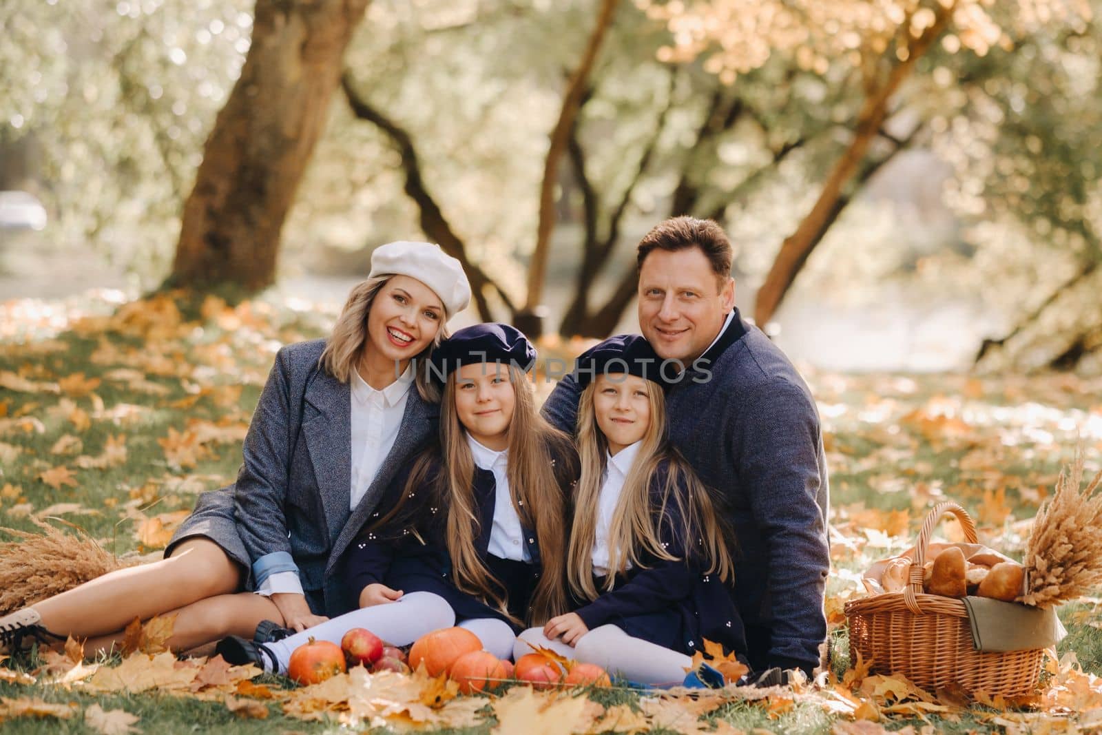 A big family on a picnic in the fall in a nature park. Happy people in the autumn park.