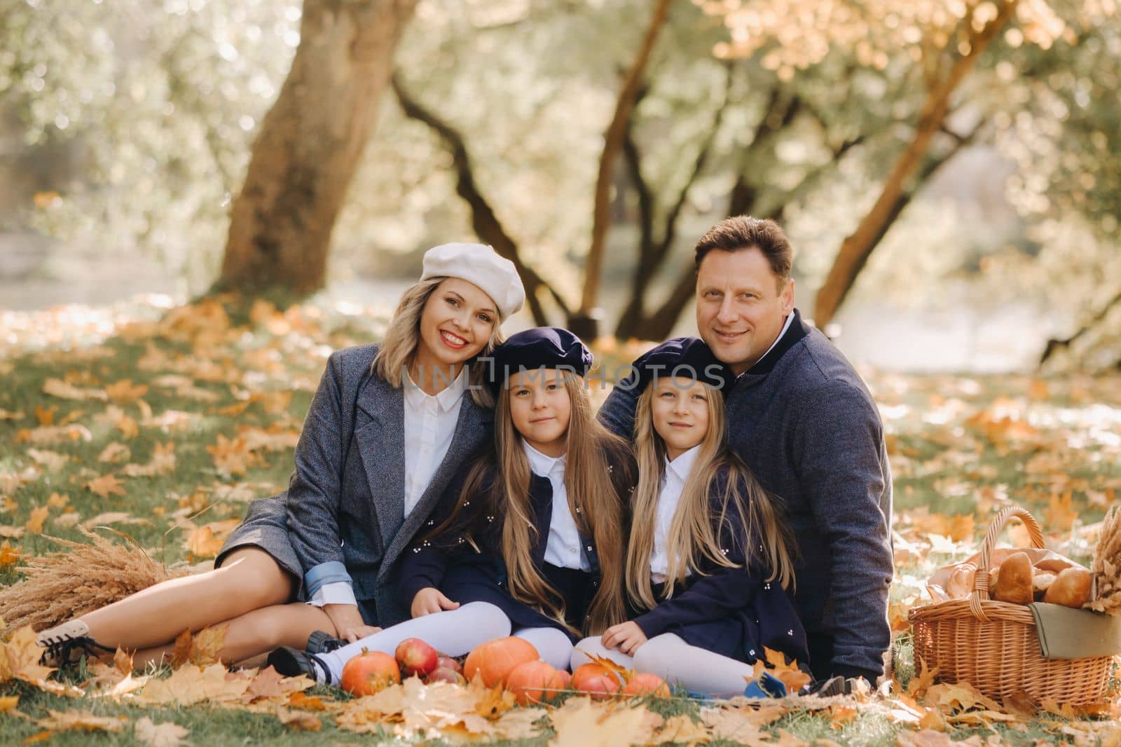 A big family on a picnic in the fall in a nature park. Happy people in the autumn park.