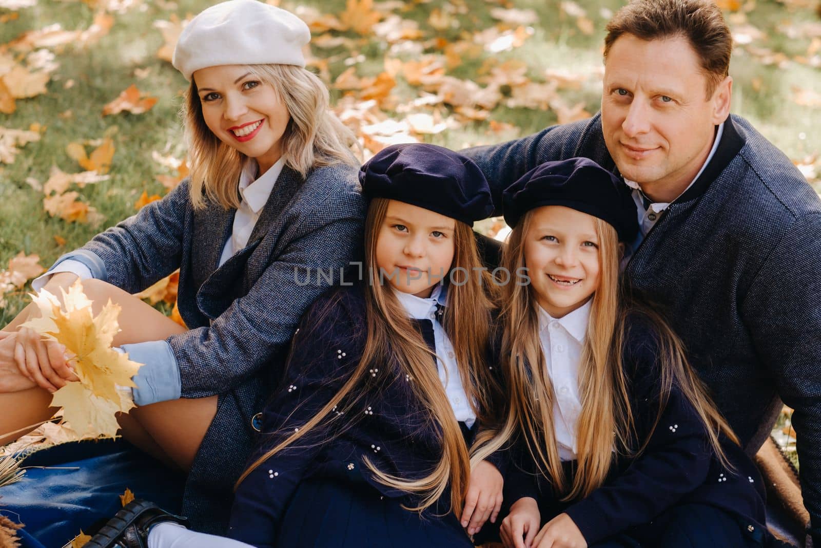 A big family on a picnic in the fall in a nature park. Happy people in the autumn park.