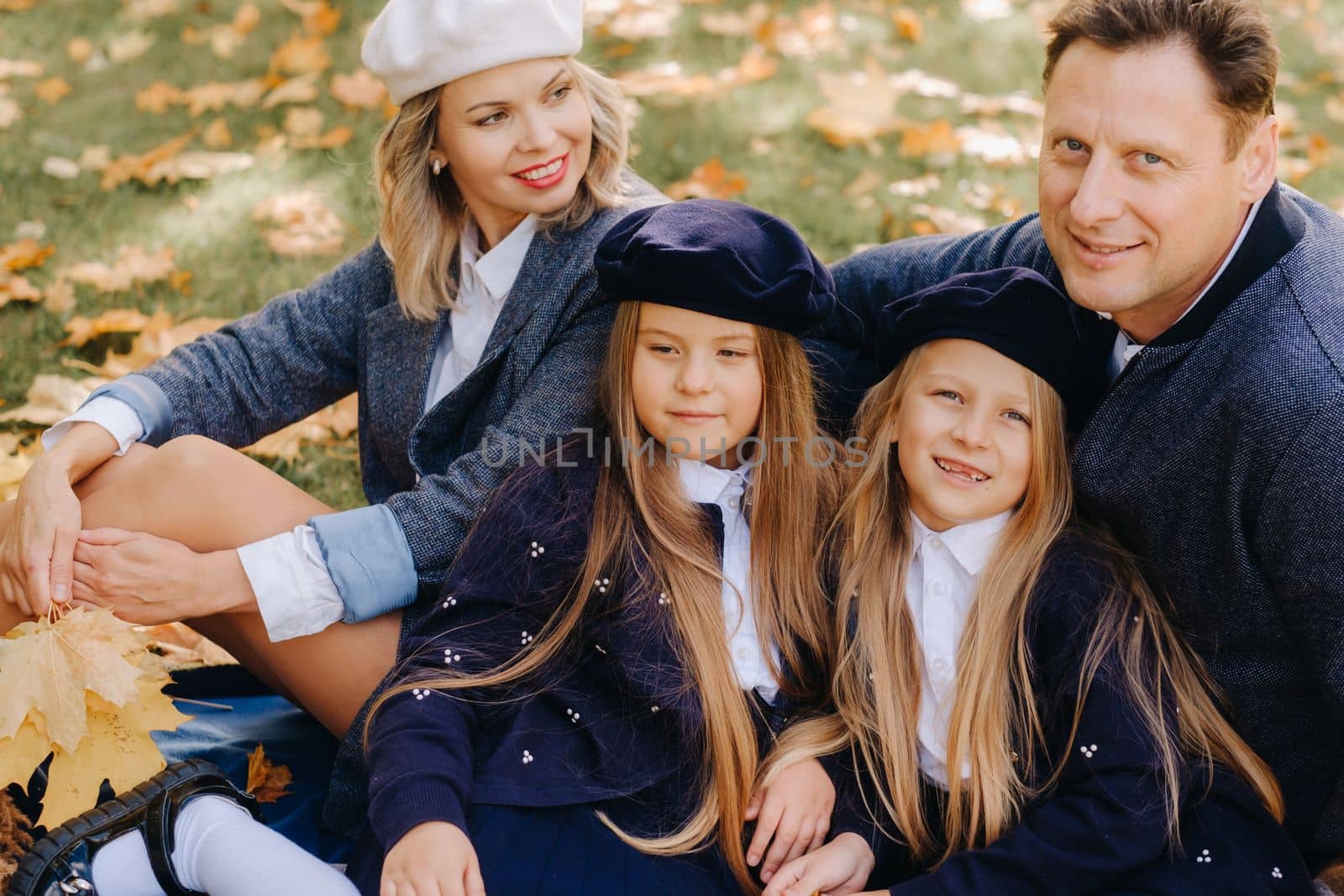 A big family on a picnic in the fall in a nature park. Happy people in the autumn park.