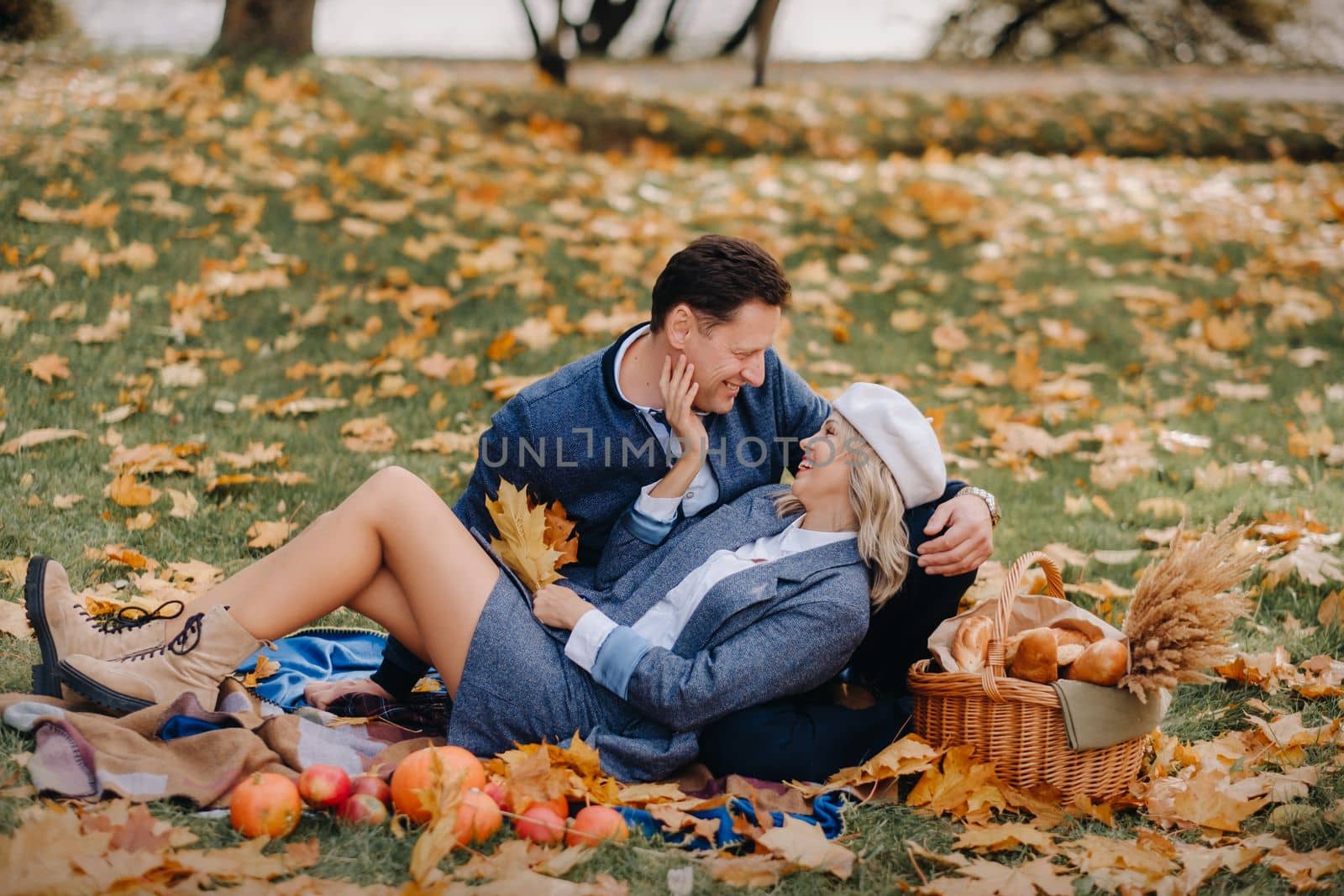 Happy couple enjoying golden autumn spring season in the park.