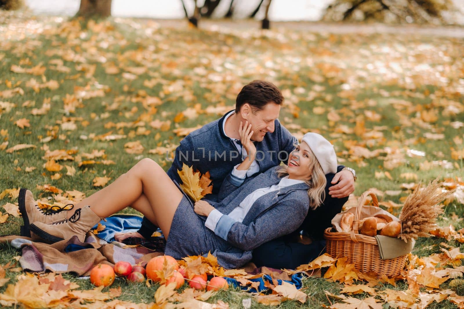 Happy couple enjoying golden autumn spring season in the park by Lobachad