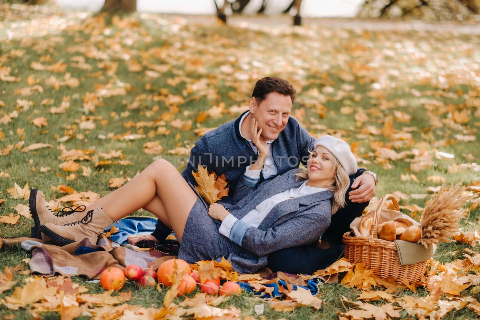 Happy couple enjoying golden autumn spring season in the park by Lobachad