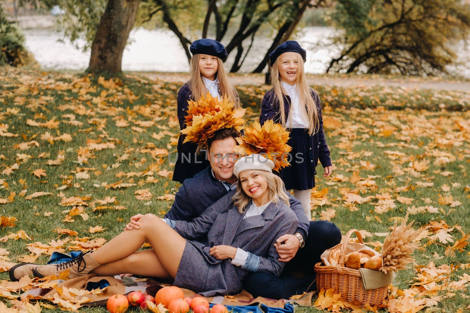 A big family on a picnic in the fall in a nature park. Happy people in the autumn park.