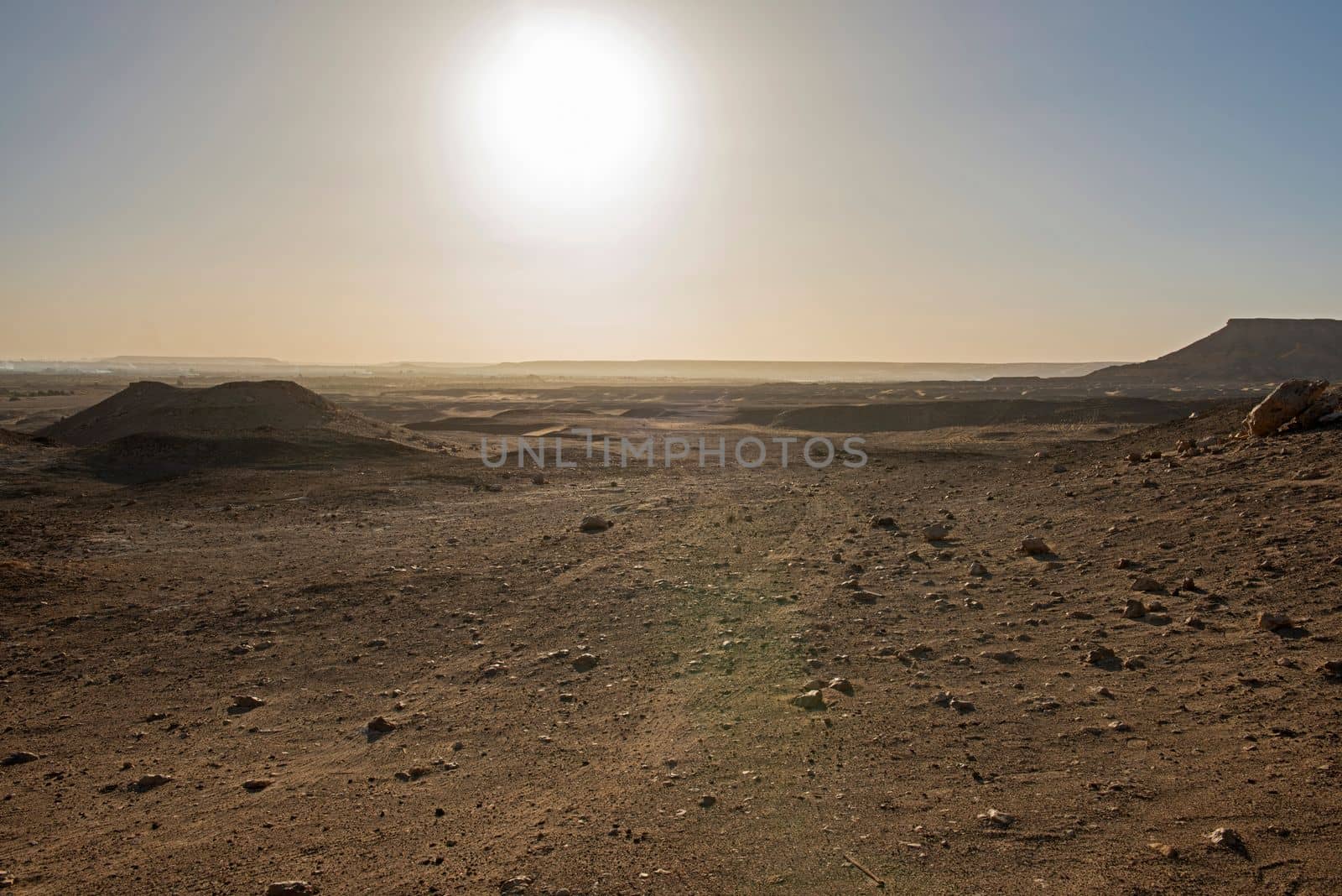 Landscape scenic view of desolate barren rocky western desert in Egypt with mountains at sunrise