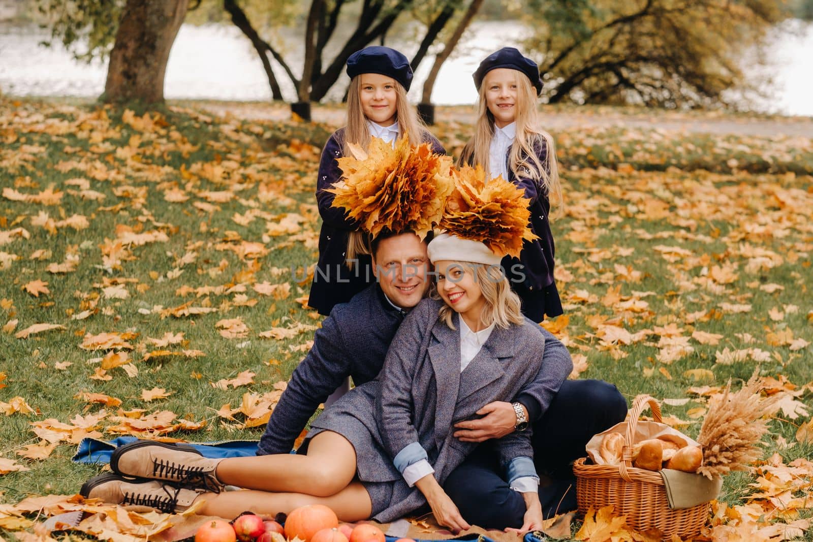 A big family on a picnic in the fall in a nature park. Happy people in the autumn park.