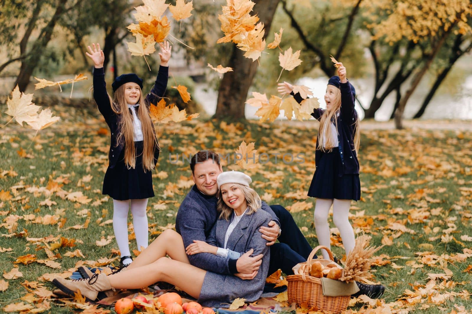 A big family on a picnic in the fall in a nature park. Happy people in the autumn park.