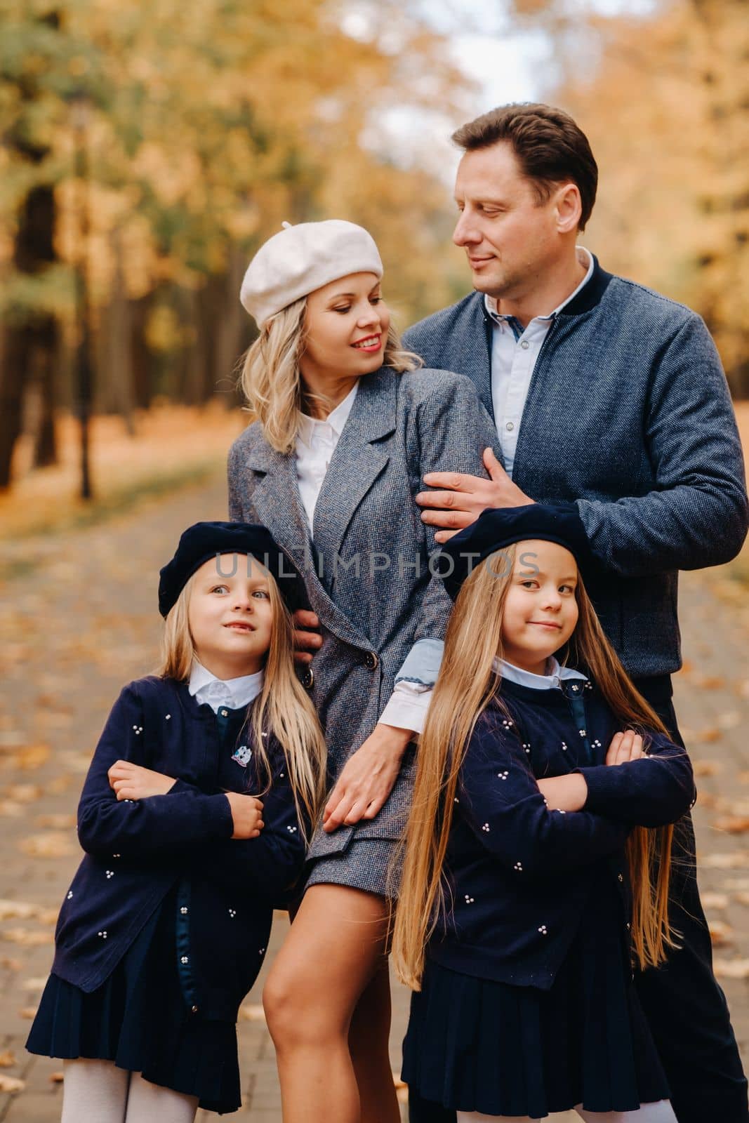 A large family walks in the park in the fall. Happy people in the autumn park.