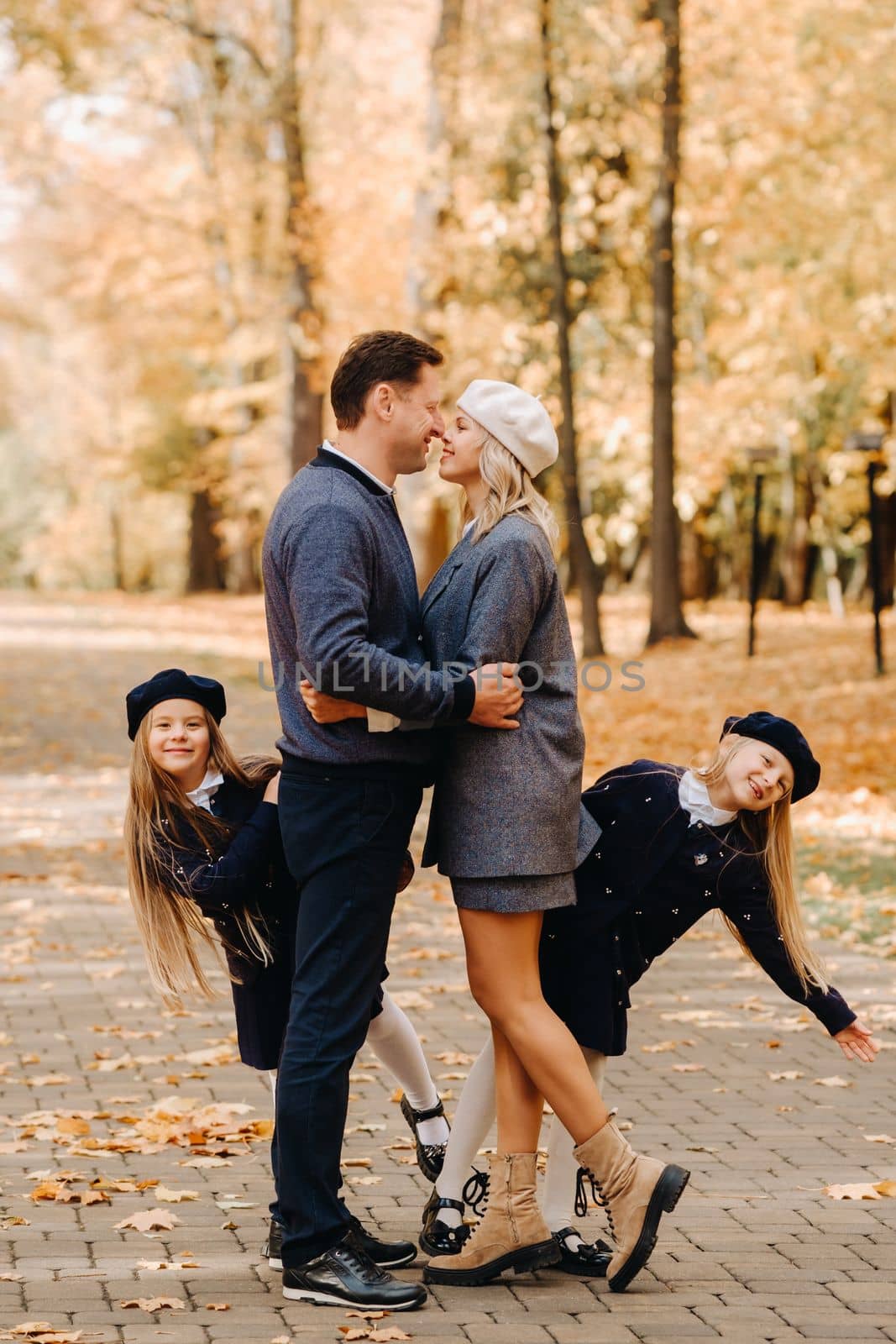 A large family walks in the park in the fall. Happy people in the autumn park.