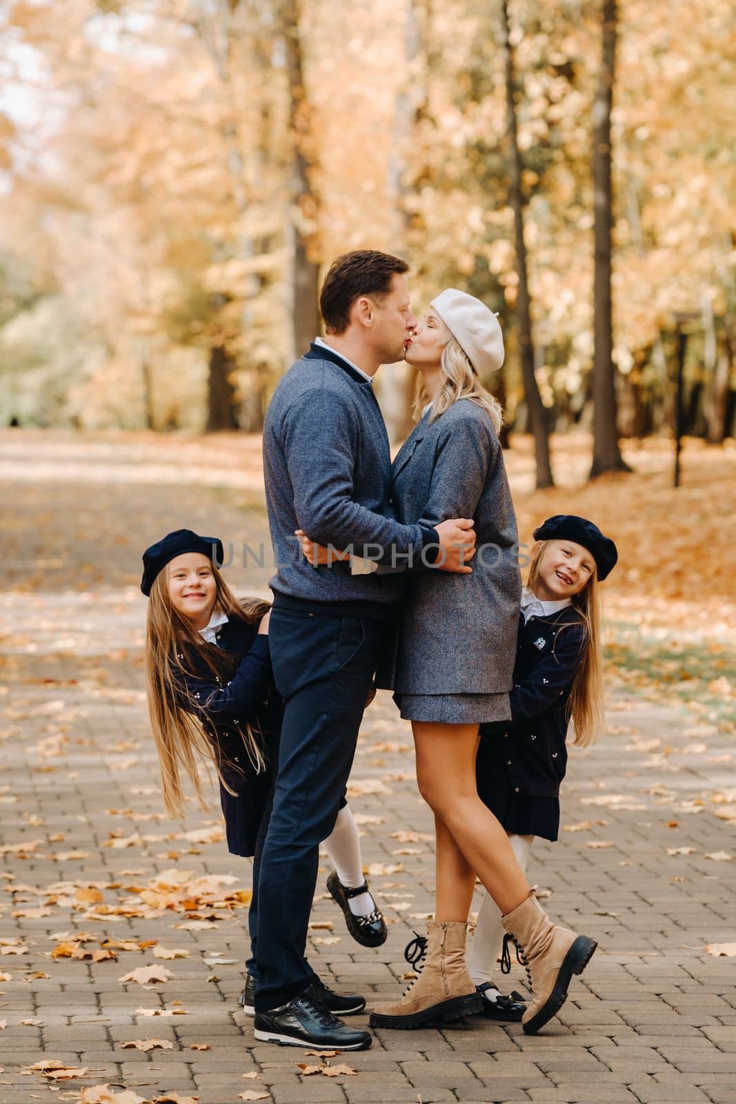 A large family walks in the park in the fall. Happy people in the autumn park.