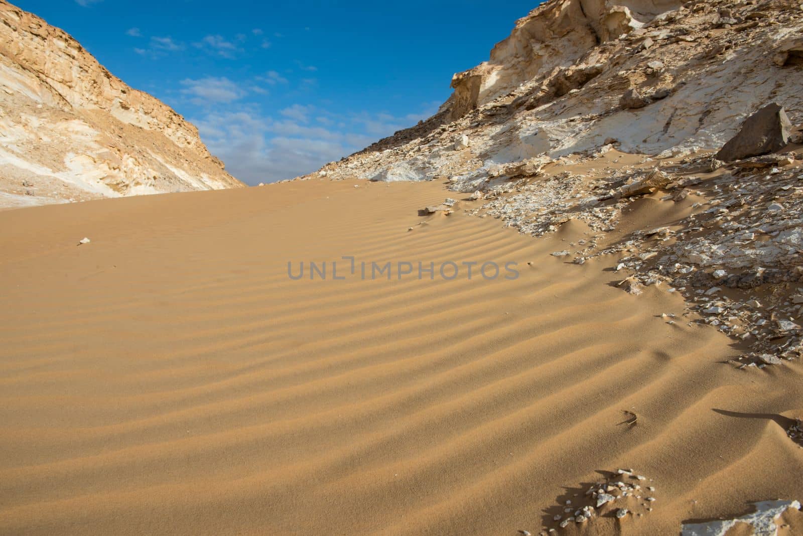 Landscape scenic view of desolate barren western desert in Egypt with sand dunes and rocky mountain