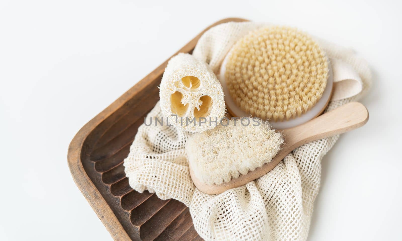 Zero waste, sustainable bathroom and lifestyle. Bamboo brush,, loofah sponge, cactus massage brush on a white background. Zero waste concept
